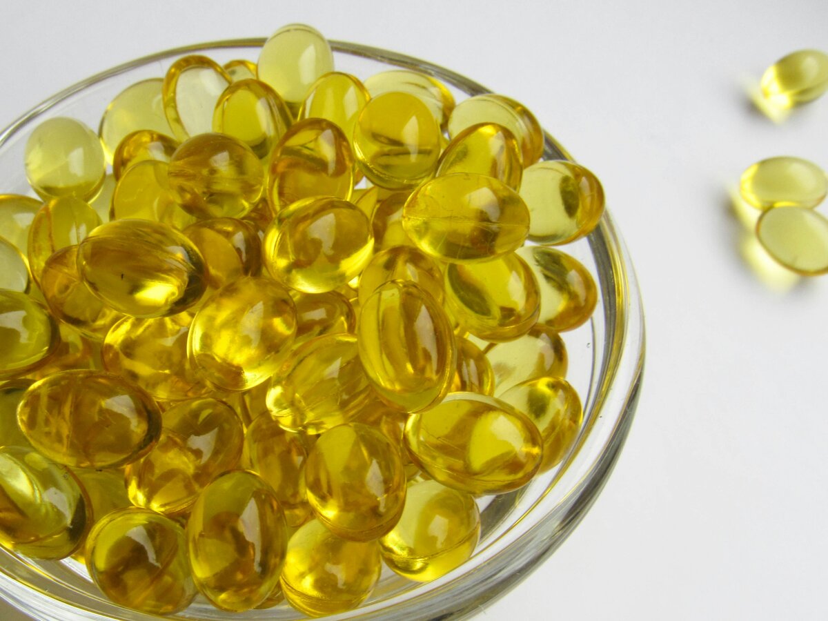 Yellow berberine supplement capsules in a glass bowl