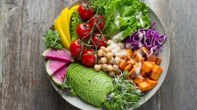 Bowl of high-fiber foods including vegetables, legumes, and whole grains that support gut microbiome and bladder health