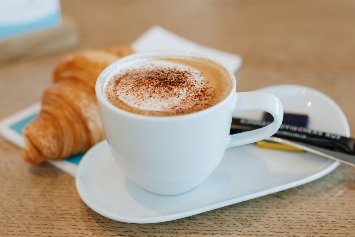 Cup of coffee on a table illustrating how caffeine affects your bladder