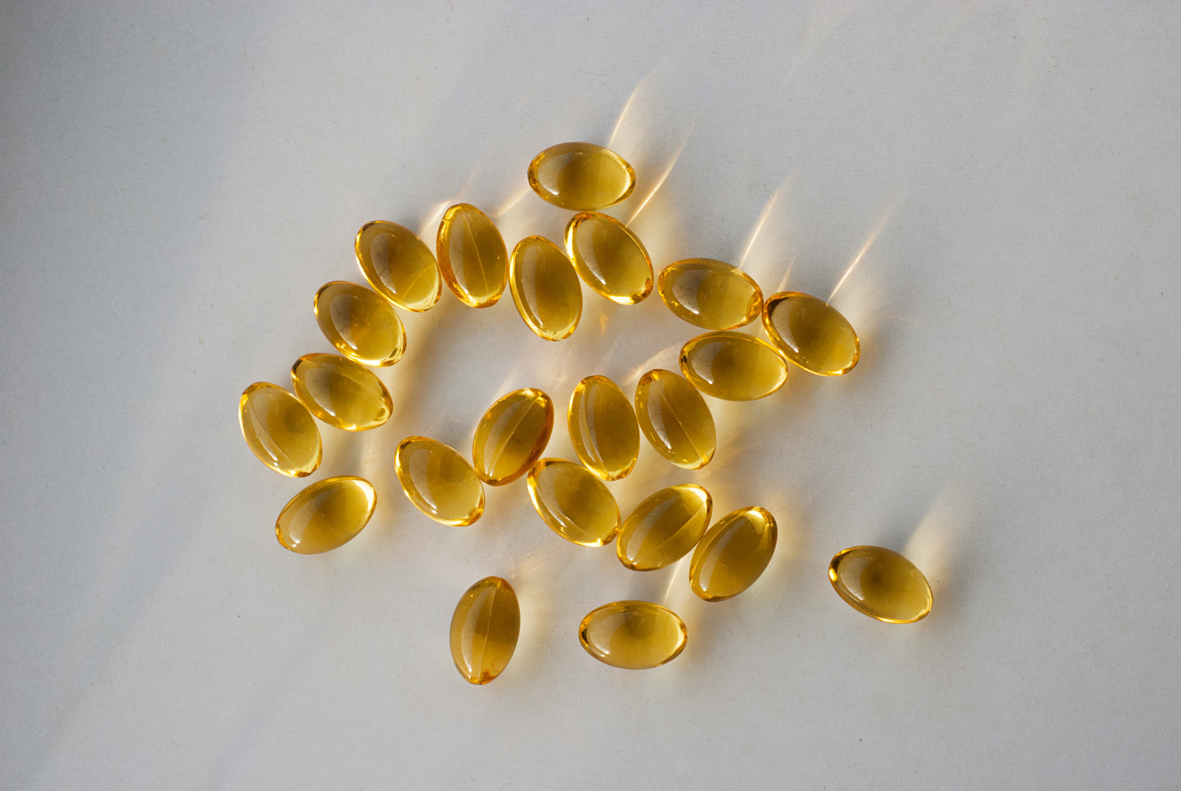 Krill oil supplement capsules alongside a glass of water for bladder health